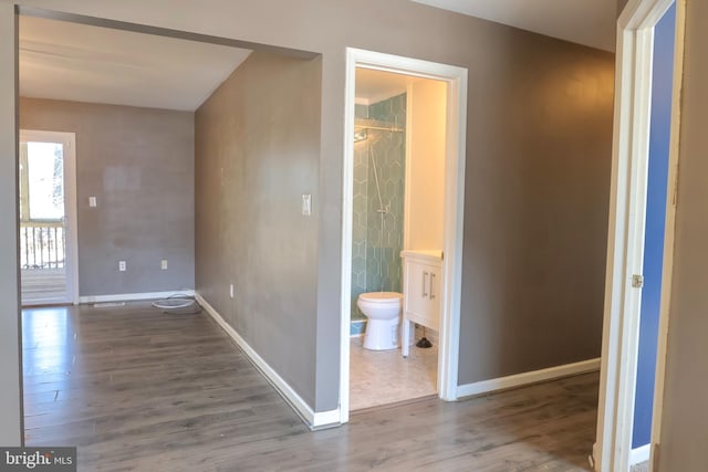 hallway with hardwood / wood-style floors