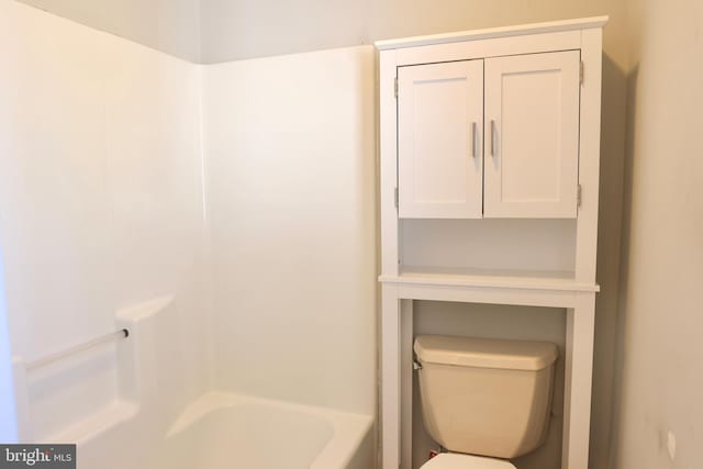 bathroom featuring a tub to relax in and toilet