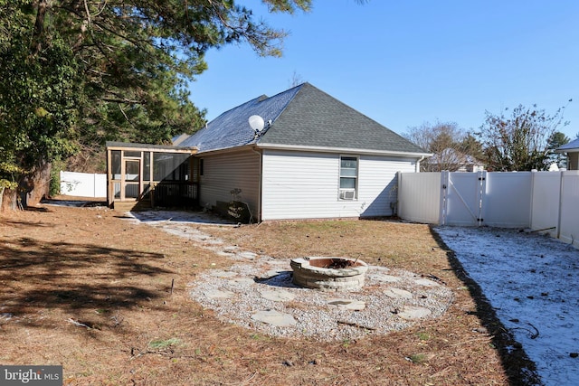 back of property featuring a fire pit