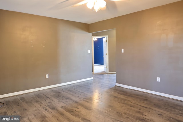 empty room with hardwood / wood-style flooring and ceiling fan