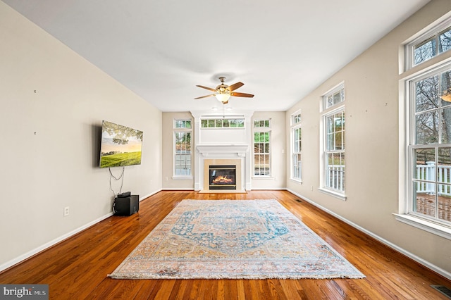 living room with hardwood / wood-style flooring, a wealth of natural light, and ceiling fan