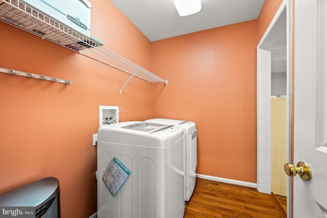 laundry room featuring washing machine and dryer and wood-type flooring