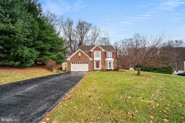 view of property with a front yard and a garage