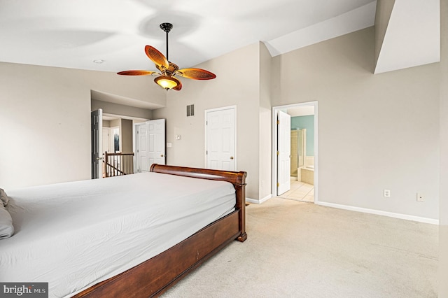 carpeted bedroom featuring ensuite bathroom, ceiling fan, and high vaulted ceiling