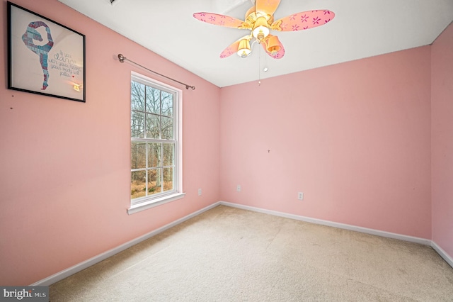 spare room with carpet floors and ceiling fan