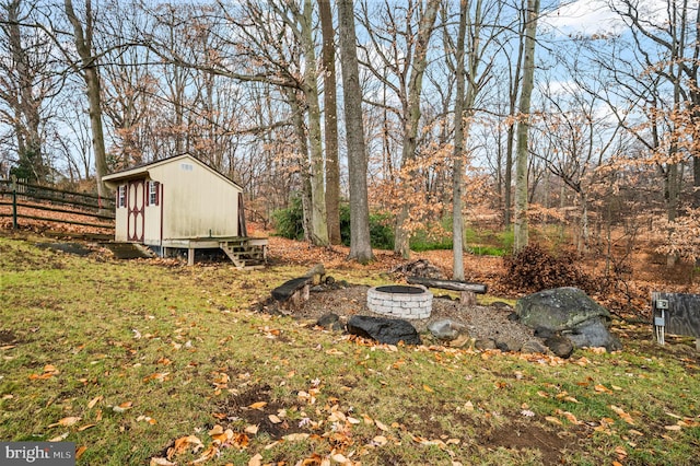 view of yard featuring a fire pit and a shed