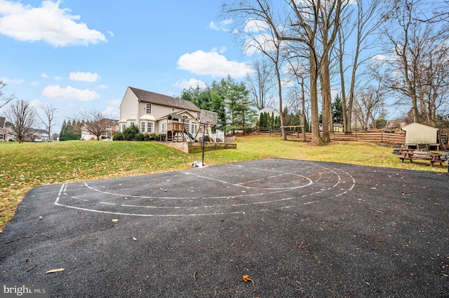 view of basketball court featuring a yard