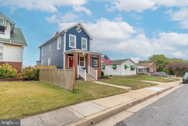 view of front of home featuring a front lawn and covered porch