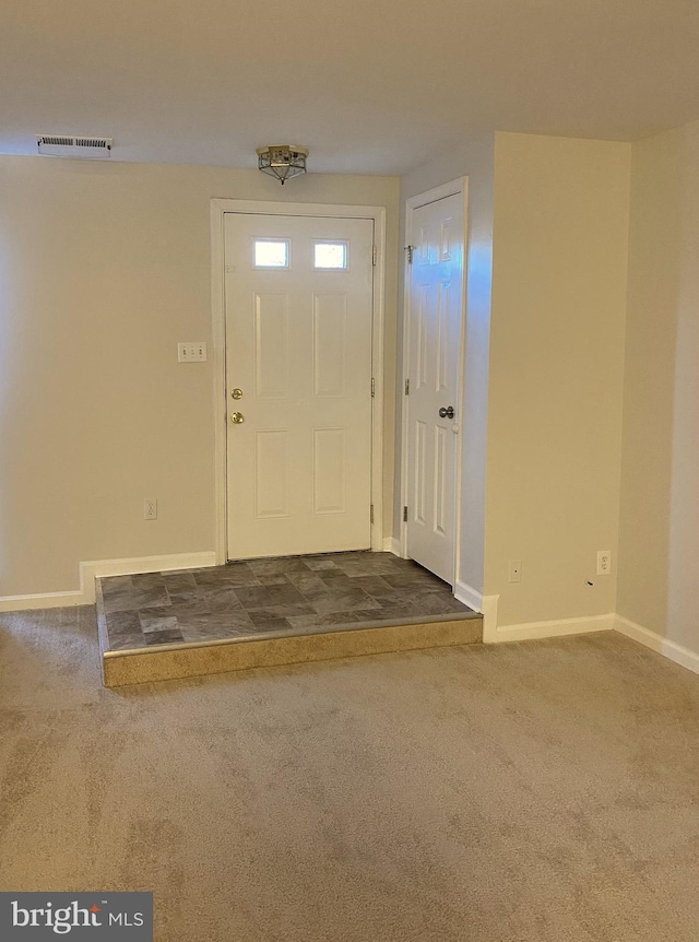 view of carpeted entrance foyer