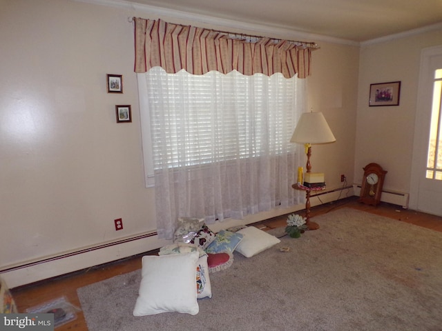 spare room with baseboard heating and ornamental molding