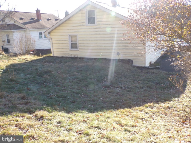 view of side of home featuring a lawn