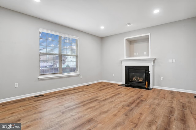 unfurnished living room with light hardwood / wood-style flooring