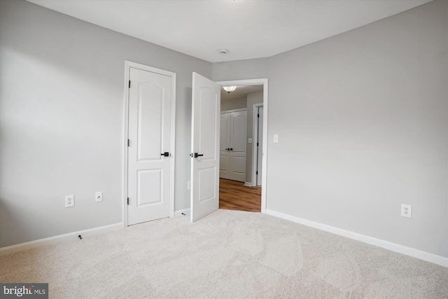 unfurnished bedroom featuring light carpet