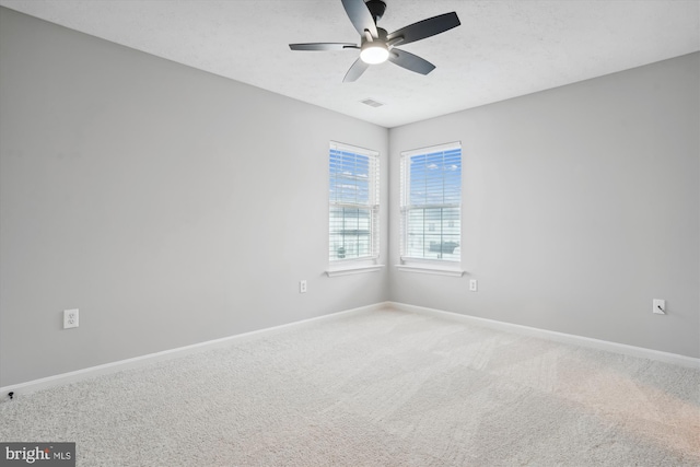 carpeted empty room featuring ceiling fan