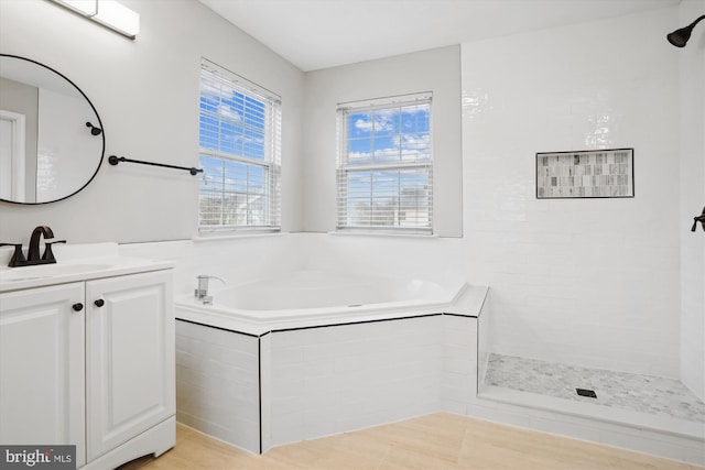 bathroom with vanity and separate shower and tub