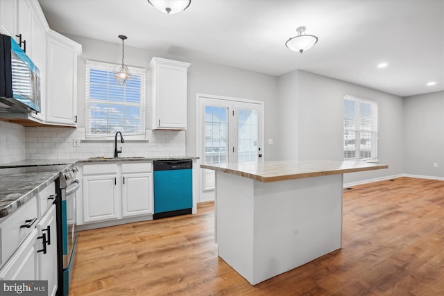 kitchen featuring a wealth of natural light, white cabinetry, and stainless steel appliances