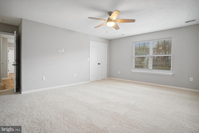 spare room with carpet flooring and ceiling fan