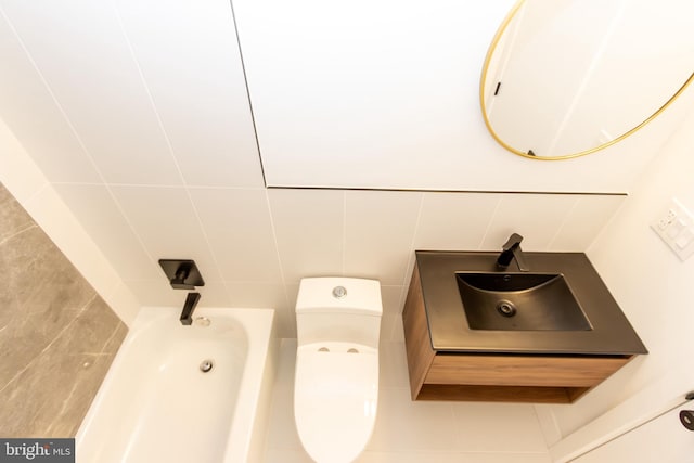 bathroom featuring sink, tile walls, and toilet