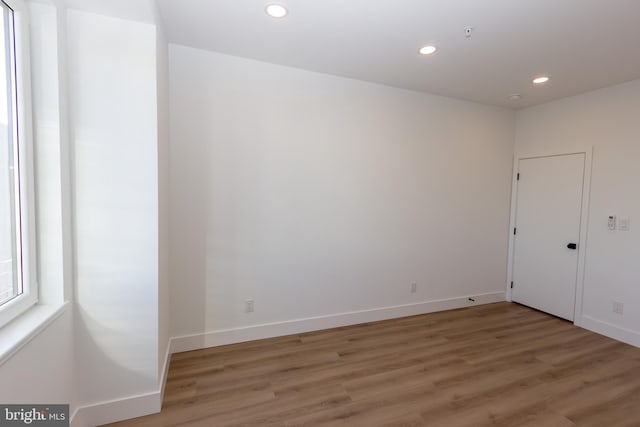 spare room with hardwood / wood-style flooring