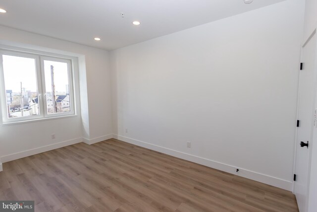 spare room with wood-type flooring