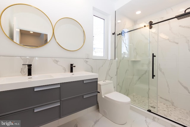 bathroom with a shower with door, vanity, tile walls, and toilet