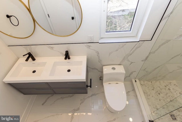 bathroom with a shower, vanity, and toilet