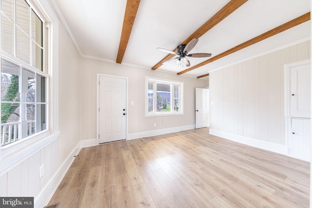 interior space with beamed ceiling, light wood-type flooring, ceiling fan, and crown molding