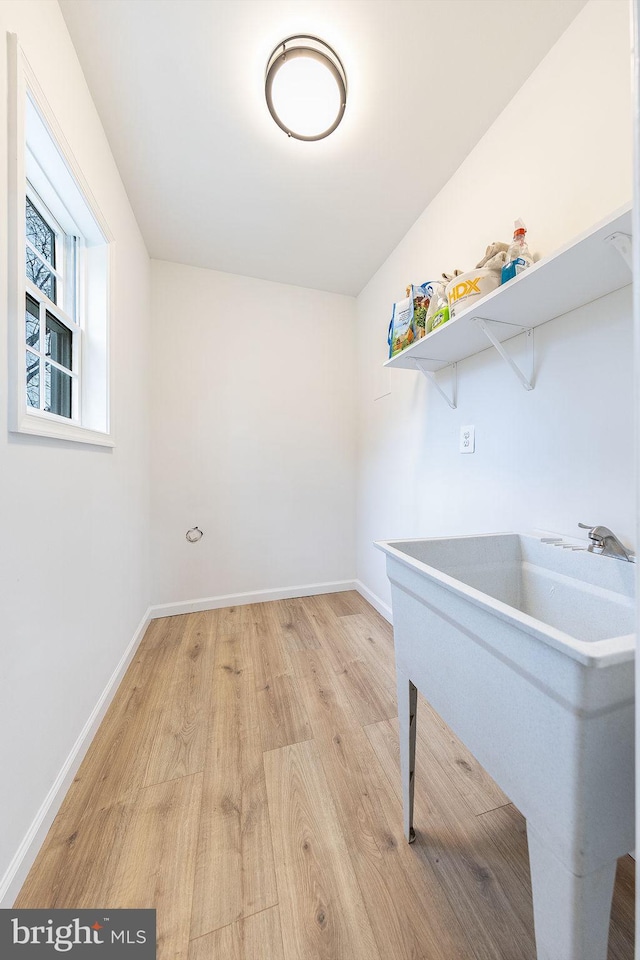 laundry room featuring light hardwood / wood-style floors