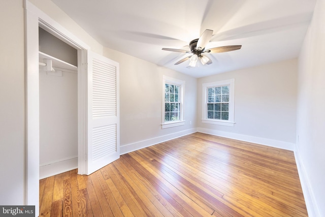 unfurnished bedroom with wood-type flooring, a closet, and ceiling fan