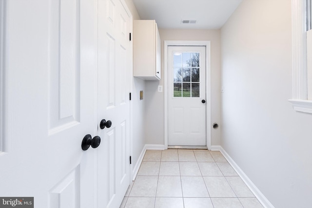 doorway with light tile patterned floors