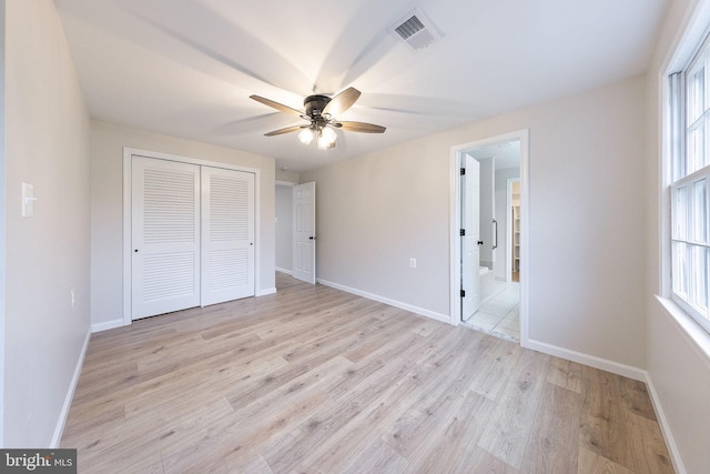 unfurnished bedroom with ceiling fan, a closet, and light hardwood / wood-style floors