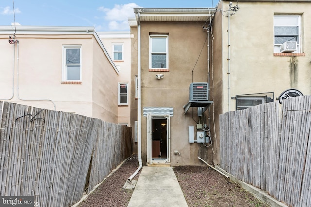 rear view of house featuring cooling unit