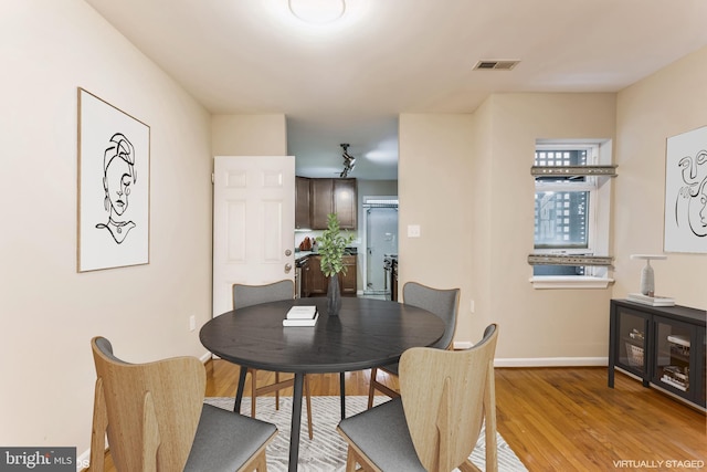 dining area with light hardwood / wood-style floors