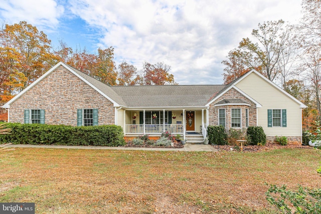 ranch-style house featuring a porch and a front yard