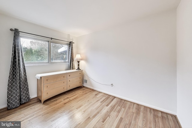 unfurnished bedroom featuring light wood-type flooring