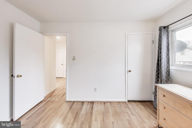 unfurnished bedroom featuring light wood-type flooring