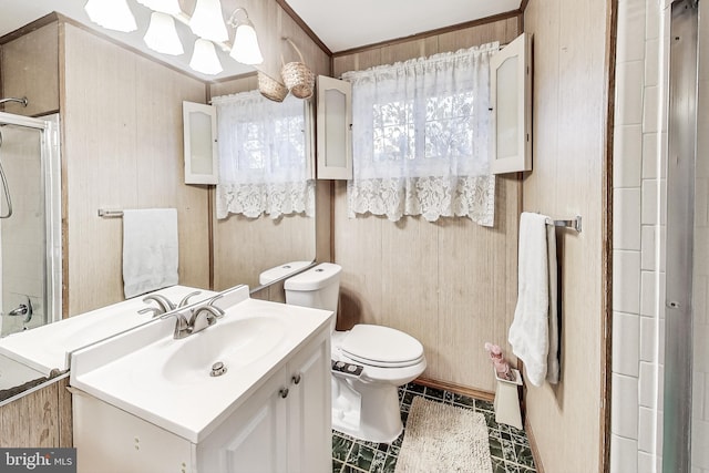 bathroom with an enclosed shower, ornamental molding, vanity, toilet, and wood walls