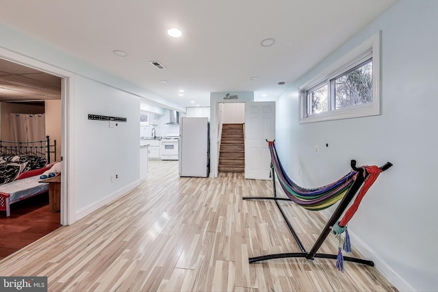 interior space featuring sink and light hardwood / wood-style floors