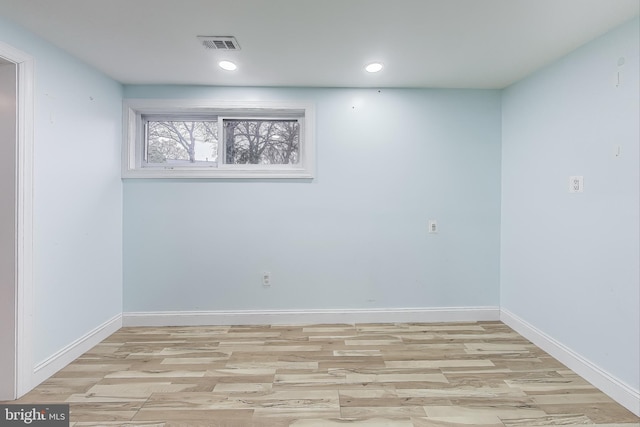 empty room with light hardwood / wood-style flooring