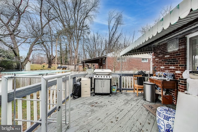 wooden terrace featuring a grill