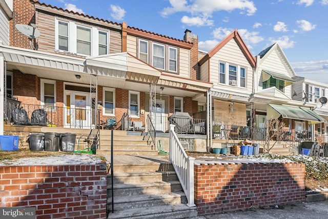 townhome / multi-family property featuring covered porch