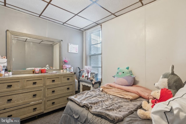 carpeted bedroom featuring a paneled ceiling