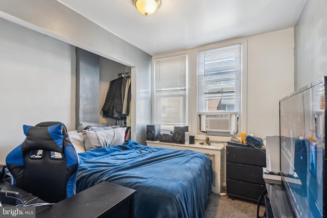 bedroom with cooling unit and carpet floors