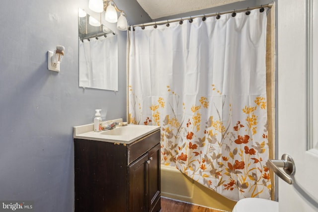 full bathroom with toilet, a textured ceiling, vanity, and shower / tub combo with curtain