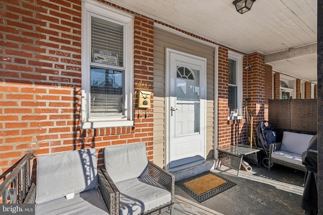 view of exterior entry featuring a porch