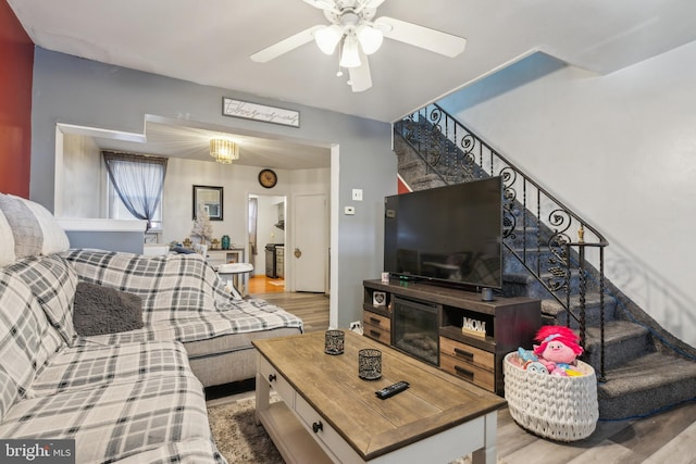 living room featuring ceiling fan and light wood-type flooring