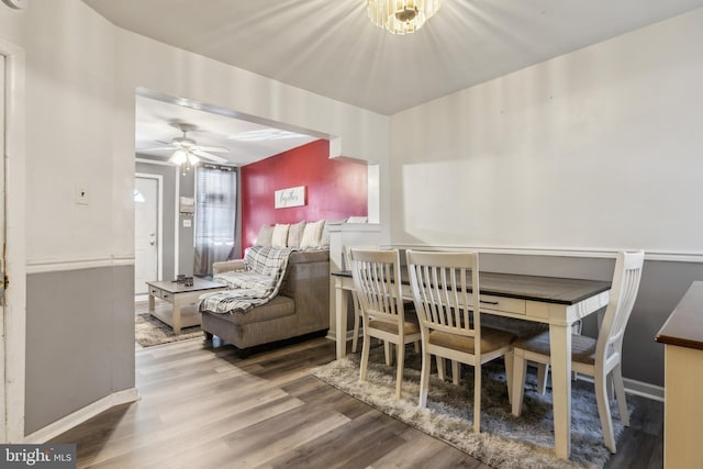 dining area with ceiling fan and hardwood / wood-style floors