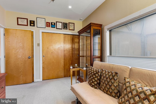 sitting room featuring light carpet