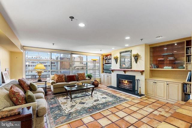 living room with built in features and a wall of windows