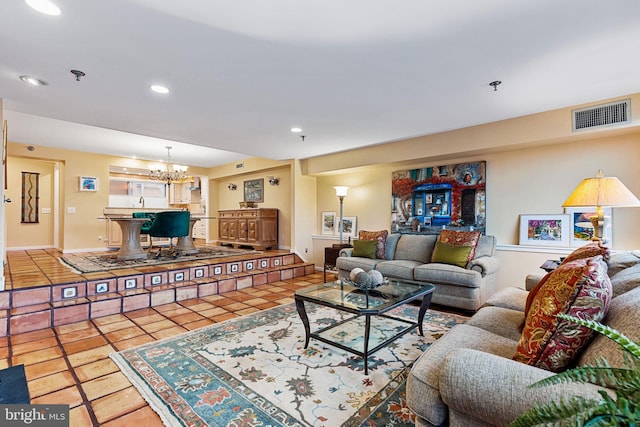 living room with light tile patterned floors and a chandelier